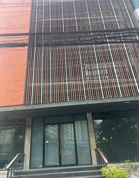 อาคารพาณิชย์ ให้เช่า - ด้านหน้าช็อปเฮาส์สมัยใหม่หลายชั้น พร้อมระแนงโลหะแนวตั้ง ประตูกระจก และบันไดทางเข้า