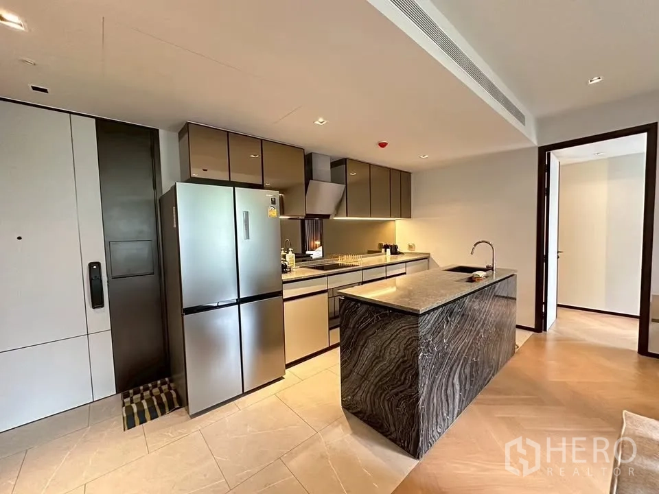 Condominium for rent in Watthana, Bangkok - Sleek kitchen with stainless refrigerator, long counters and stone island.