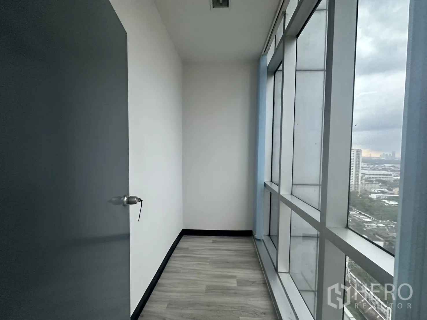 Office Space for rent - Narrow windowed alcove ideal for storage or phone booth with skyline outlook.