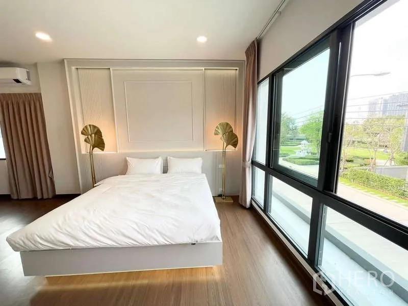 Detached House for rent in Bang Phli, Samut Prakan - Corner bedroom with large windows and green garden view.