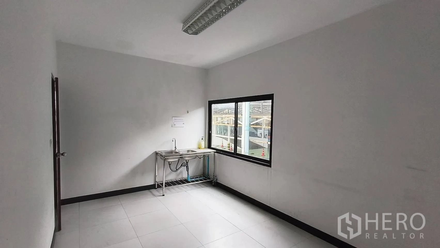 Office Space for rent in Khlong Toei, Bangkok - Pantry with stainless steel double sink and a window.
