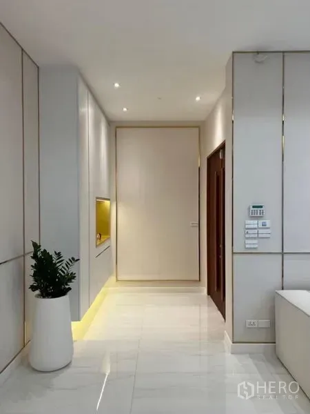 Detached House for rent - Bright entry hall with built-in cabinet, white walls and a potted plant.