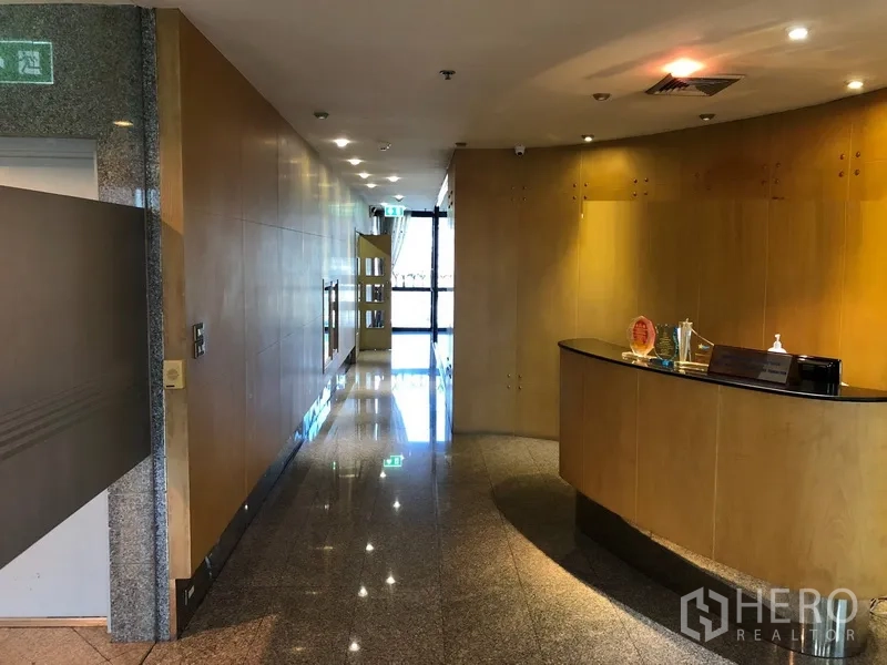 Office Space for rent in Bang Na, Bangkok - Office lobby and corridor with granite floor, wood wall panels and recessed lighting in Khlong Toei, Bangkok.