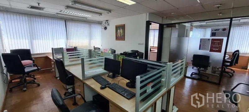 Office Space for rent in Watthana, Bangkok - Bright workspace with desk clusters, vertical blinds, glass partitions, and overhead fluorescent lighting.