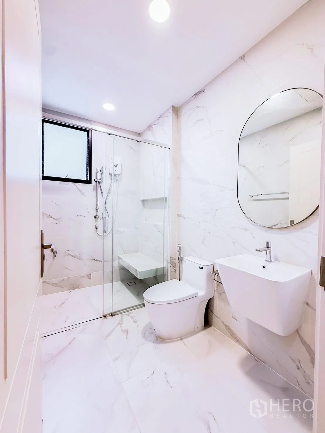 Detached House for rent in Saphan Sung, Bangkok - White bathroom with glass shower and bench.
