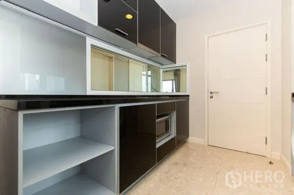 公寓 出租在Khlong Toei, Bangkok - 独立厨房配黑色高光柜体、台面与嵌入式微波炉及储物格。