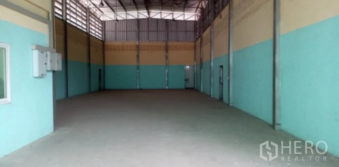 โกดัง for rent in Mueang Nonthaburi, Nonthaburi - มุมมองกว้างของโถงโกดัง เห็นตู้ไฟ ระบบระบายอากาศ และพื้นที่โล่งไร้เสากลาง