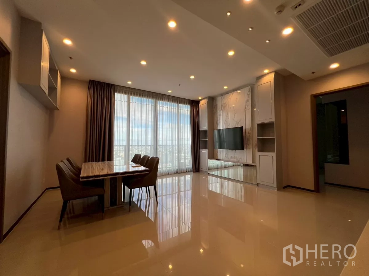 Condominium for rent in Phra Khanong, Bangkok - Open-plan living and dining room with marble TV wall, recessed lights, and floor-to-ceiling windows at Whizdom Essence Sukhumvit.