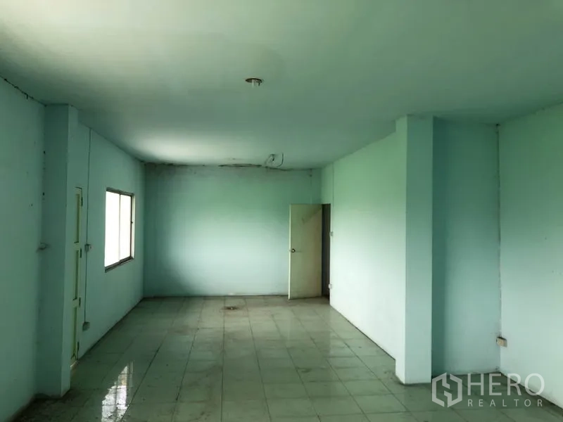 Warehouse for rent in Nonthaburi - Second view of tiled mezzanine office area with ceiling lights.