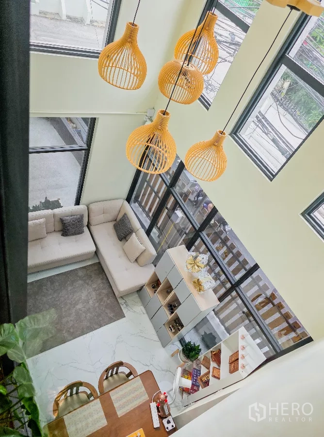 อาคารพาณิชย์ ให้เช่าในWatthana, Bangkok - พื้นที่นั่งเล่นเพดานสูงสองชั้น มีหน้าต่างสูงและโคมไฟหวายแขวน