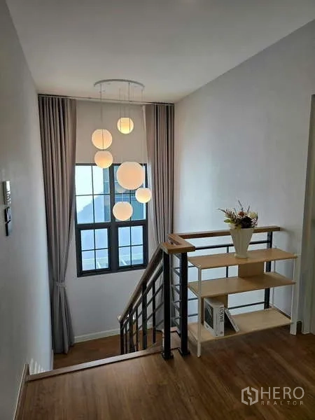 Detached House for rent in Bang Phli, Samut Prakan - Stairwell with pendant lighting, handrail and tall window.