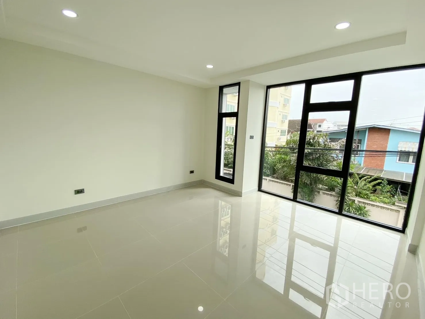 Home Office for rent or sale in Phra Khanong, Bangkok - Large office space with full-height windows and glossy tiles.