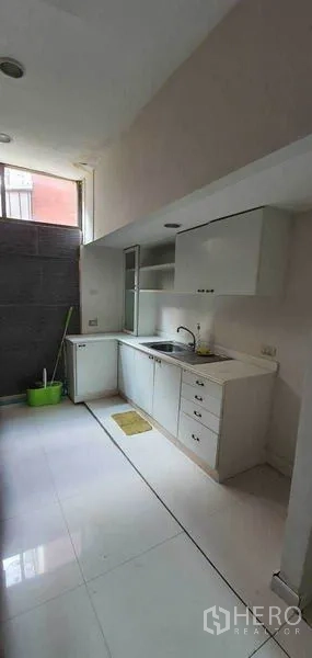 Home Office for rent in Watthana, Bangkok - Compact pantry kitchen with white cabinets, sink and a high window.