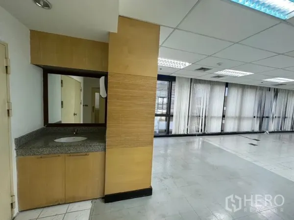 Office Space for rent in Khlong Toei, Bangkok - Built‑in washbasin counter with mirror next to the open office area.