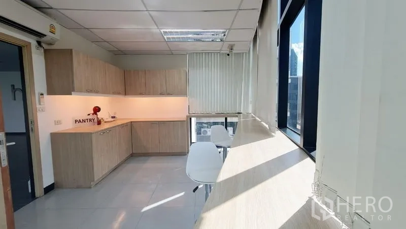 Office Space for rent in Watthana, Bangkok - Bright pantry with bar seating by the windows and a city outlook.