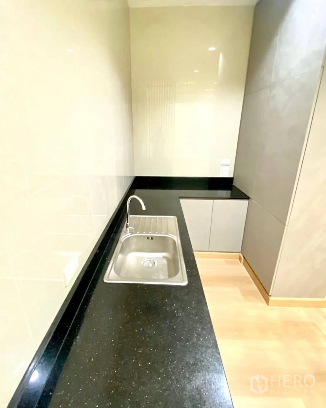 Office Space for rent - Pantry with black stone countertop, sink and storage cabinets.