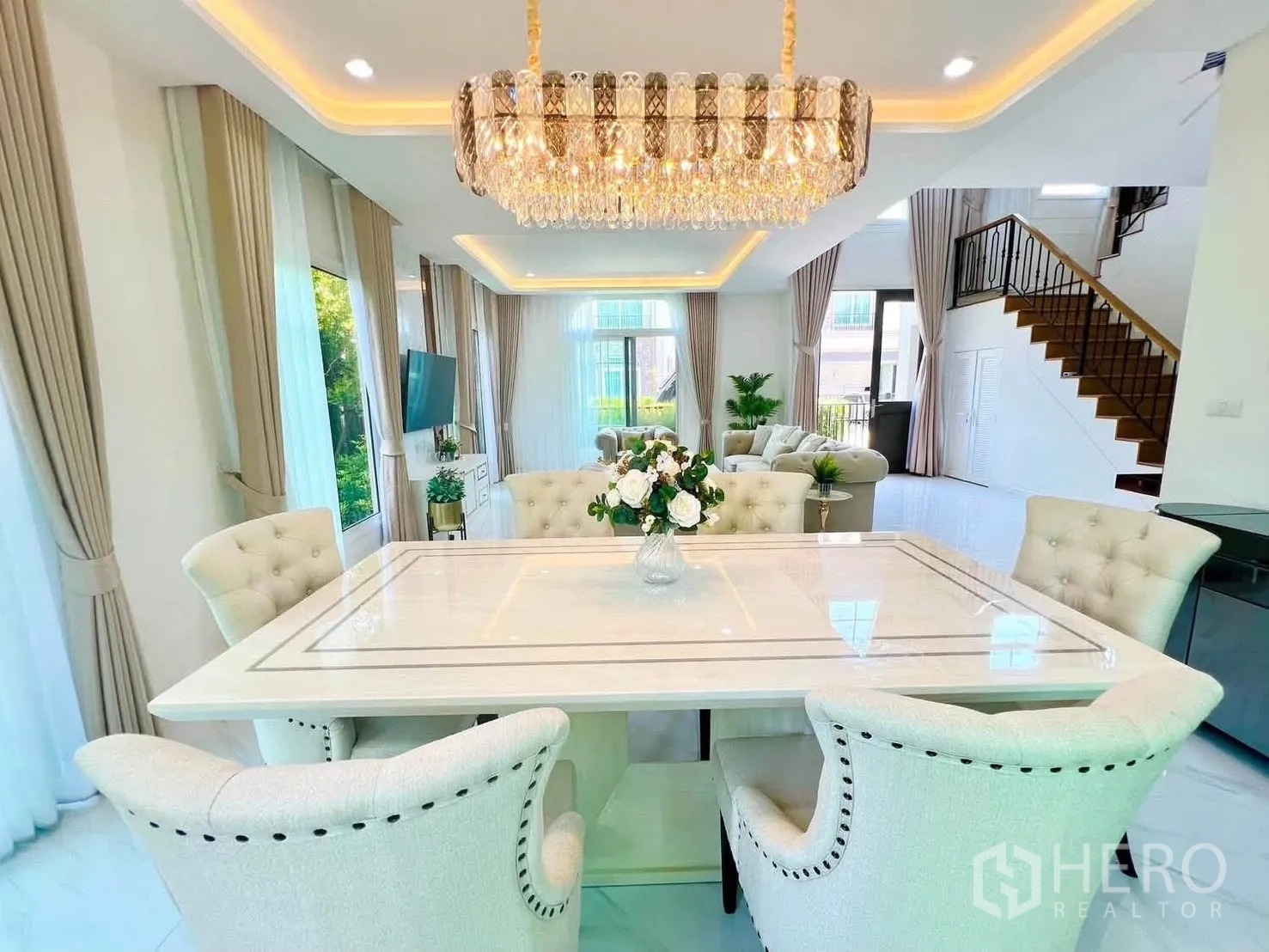 Detached House for rent in Bang Phli, Samut Prakan - Dining area with a marble-top table, six upholstered chairs, and a crystal chandelier.