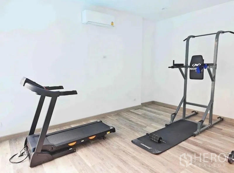 Detached House for rent - Home gym room with treadmill and power tower on vinyl flooring.