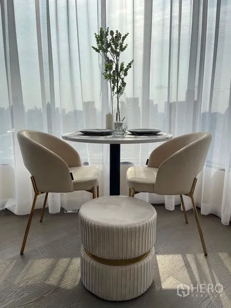 Condominium for rent - Small round dining set by sheer curtains bringing in soft natural light.