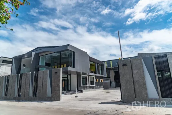 Warehouse for sale in Bang Khen, Bangkok - Contemporary two‑storey office and warehouse complex with secure perimeter wall.