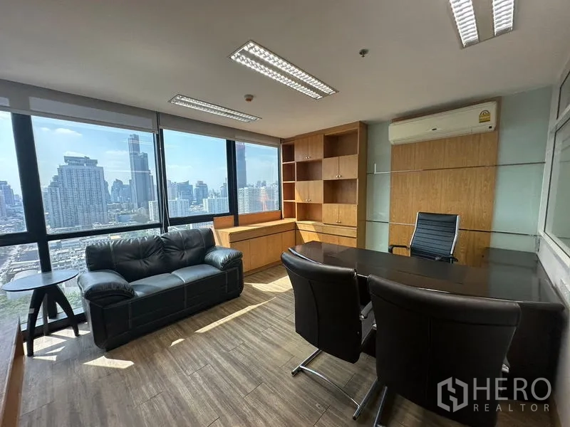 Office Space for rent or sale - Executive office with skyline view, leather sofa and built-in cabinetry.