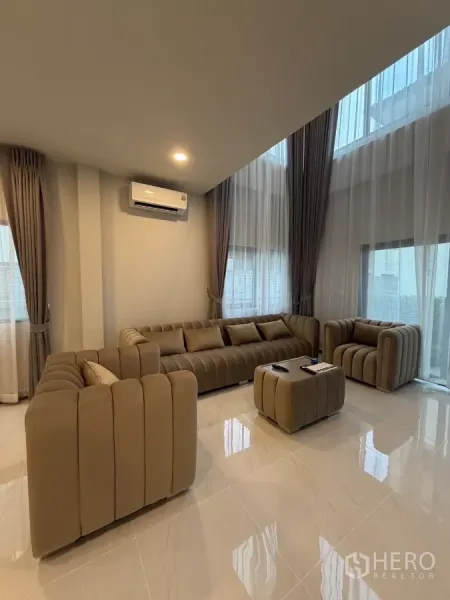 บ้าน ให้เช่าในBang Phli, Samut Prakan - ห้องนั่งเล่นเพดานขนาดสองชั้น โซฟาขนาดใหญ่ พื้นกระเบื้องเงา