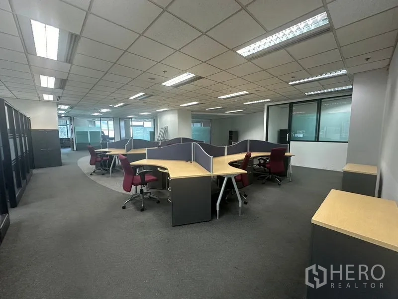 Office Space for rent in Khlong Toei, Bangkok - Open-plan workspace with modular cubicles and task chairs under fluorescent lights.