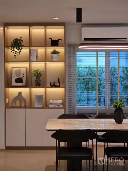 Detached House for rent in Bang Phli, Samut Prakan - Close-up of dining zone with illuminated built-in shelves and window blinds.