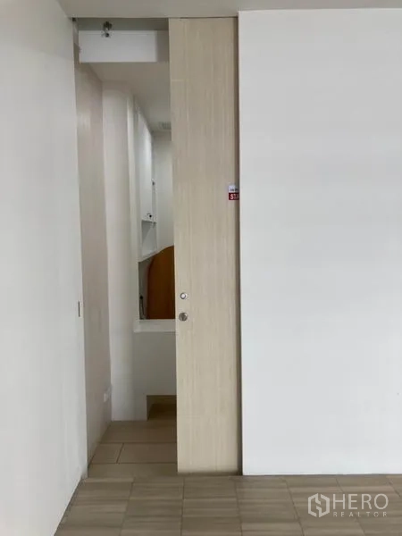 Office Space for rent in Khlong Toei, Bangkok - Pantry or storage room with tall white cabinets and long work counter.