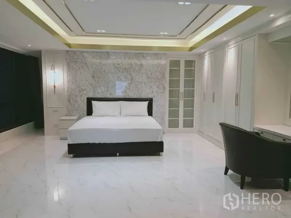 Condominium for  in Watthana, Bangkok - Large master bedroom with marble feature wall and full-height wardrobes.