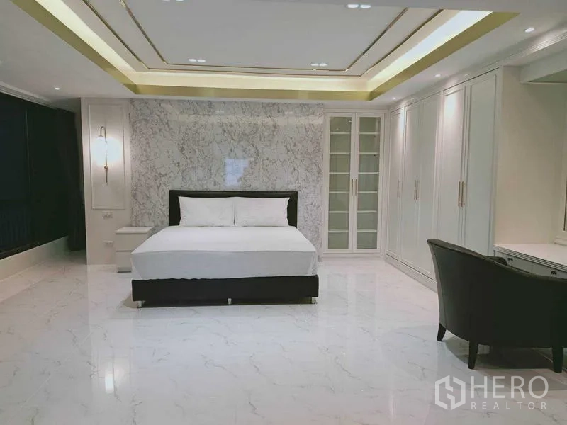 Condominium for  in Watthana, Bangkok - Large master bedroom with marble feature wall and full-height wardrobes.