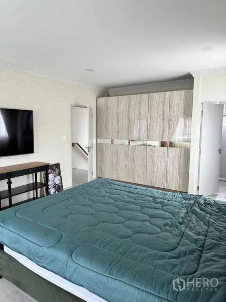 Detached House for sale in Bang Phli, Samut Prakan - Master bedroom showing built-in wardrobe and ensuite door