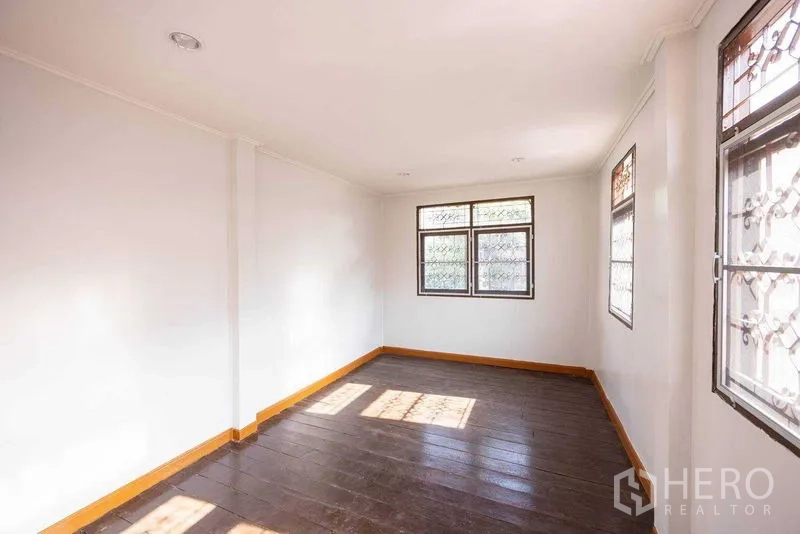 Home Office for rent in Watthana, Bangkok - Sunlit upper room with double windows and wood flooring suitable for meeting room.