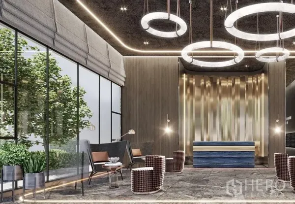 Condominium for sale in Khlong Toei, Bangkok - Design-led condominium lobby with ring chandeliers, a reception desk, and floor-to-ceiling windows opening to greenery.