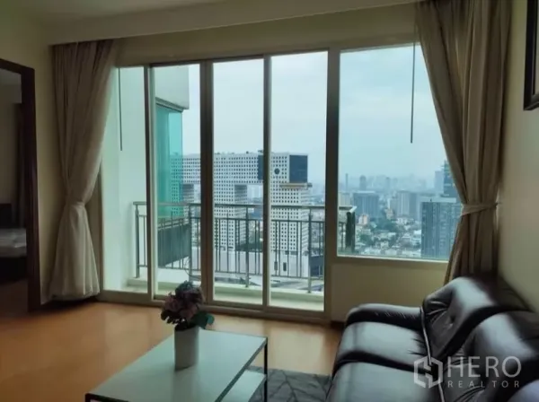 Condominium for rent in Chatuchak, Bangkok - Close view of sliding glass doors to the balcony with sweeping cityscape.