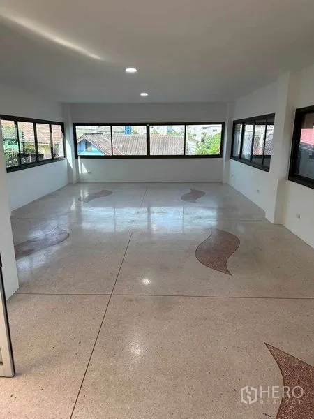 Home Office for sale - Open-plan workspace with terrazzo floor and panoramic windows on three sides.