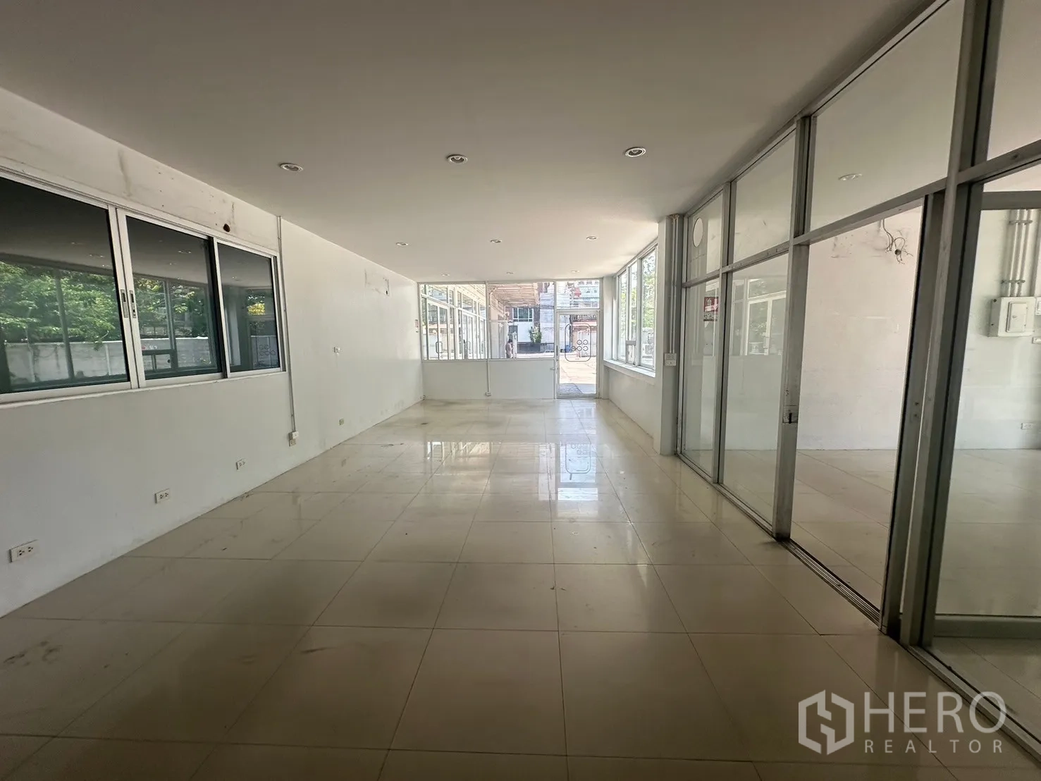 Warehouse for rent in Din Daeng, Bangkok - Long glass-lined corridor office space facing the front courtyard.