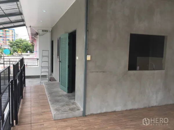 บ้าน ให้เช่าในDin Daeng, Bangkok - มุมระเบียงพร้อมประตูลูกฟักระบายอากาศสีเขียว ช่องบริการ และอ่างล้างมือ