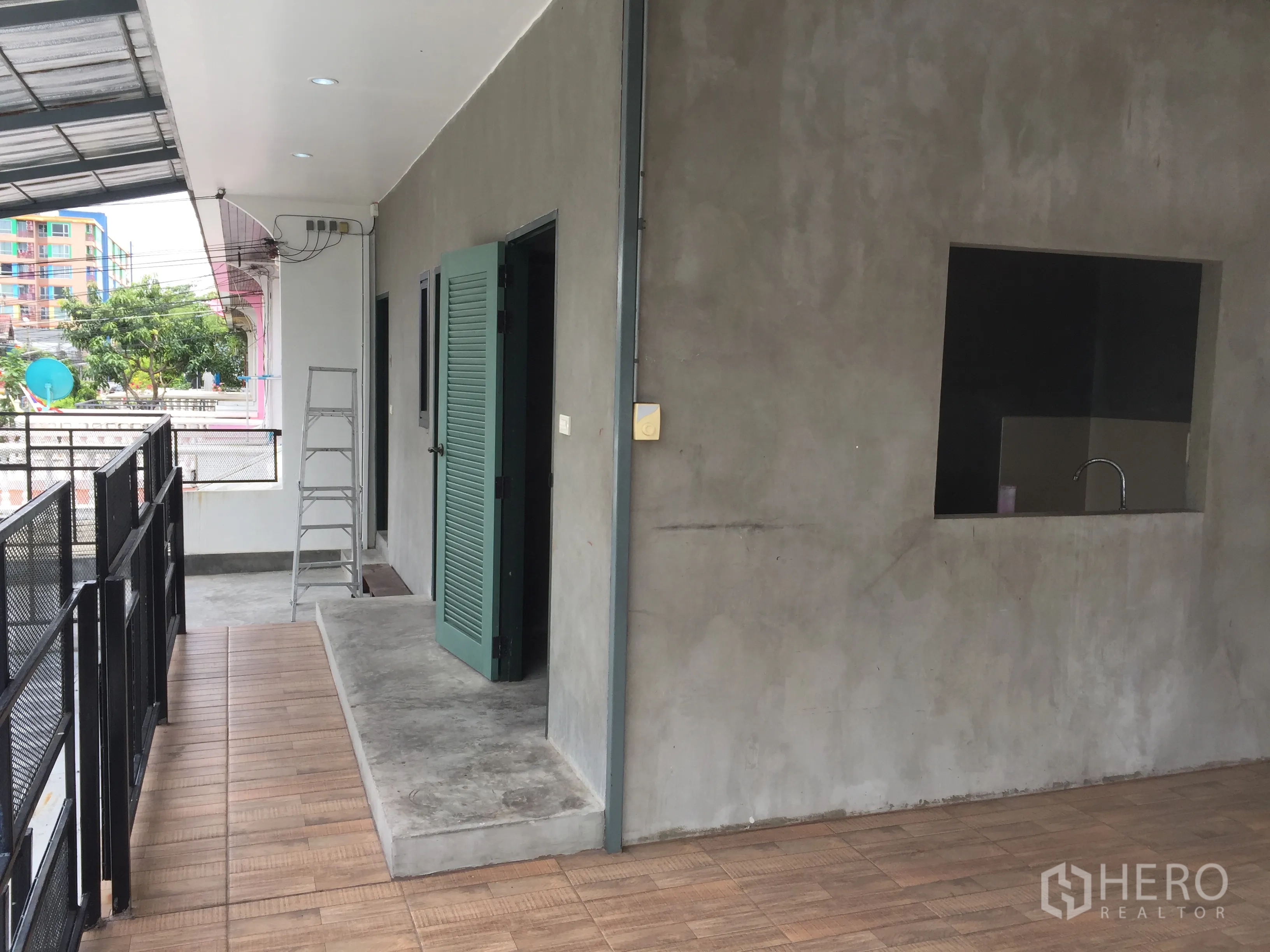 บ้าน ให้เช่าในDin Daeng, Bangkok - มุมระเบียงพร้อมประตูลูกฟักระบายอากาศสีเขียว ช่องบริการ และอ่างล้างมือ