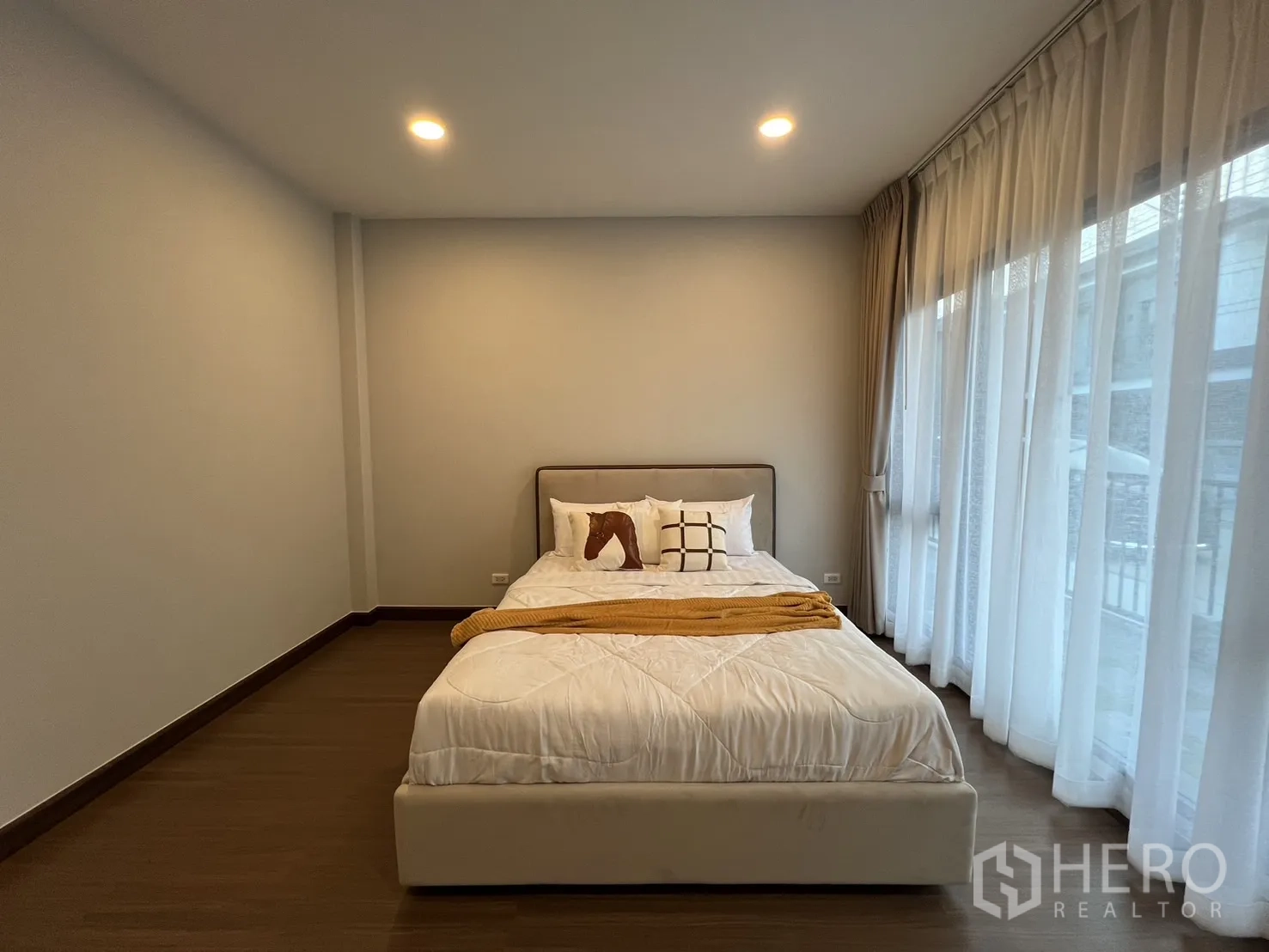 Detached House for rent or sale in Bang Phli, Samut Prakan - Bedroom view showing bed, built-in media shelf and sheer curtains.