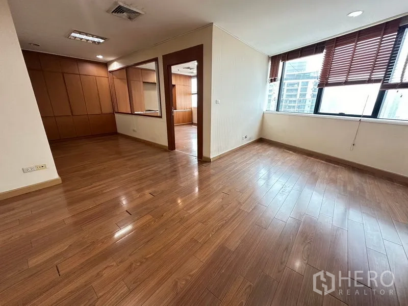 Office Space for rent - Corner workspace with natural light, wood floors and an internal glass window to adjoining room.