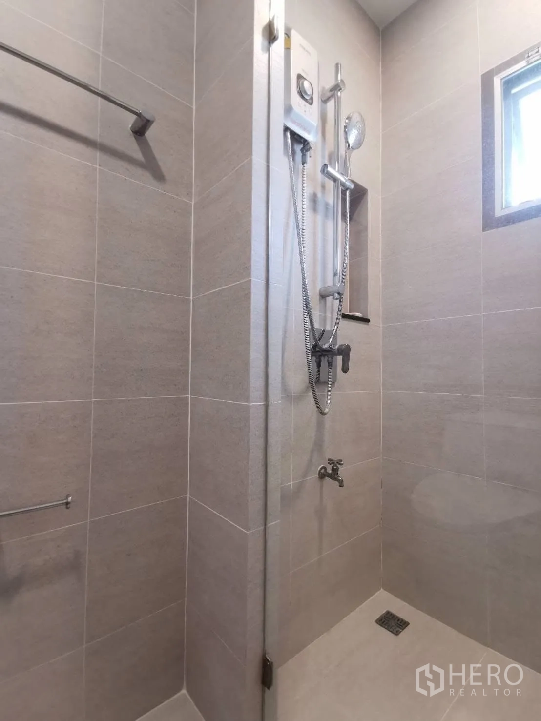 Detached House for rent in Bang Phli, Samut Prakan - Tiled walk-in shower with water heater unit, glass partition, and a small ventilation window.