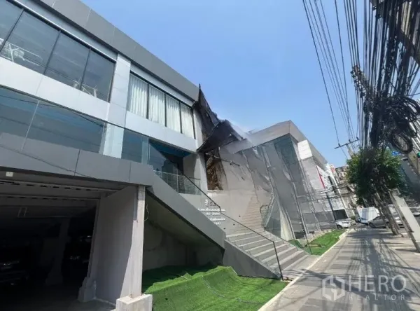 零售空间 出租在Huai Khwang, Bangkok - 曼谷 Huai Khwang 区多层现代零售楼，大片玻璃立面、临街楼梯与宽人行道。