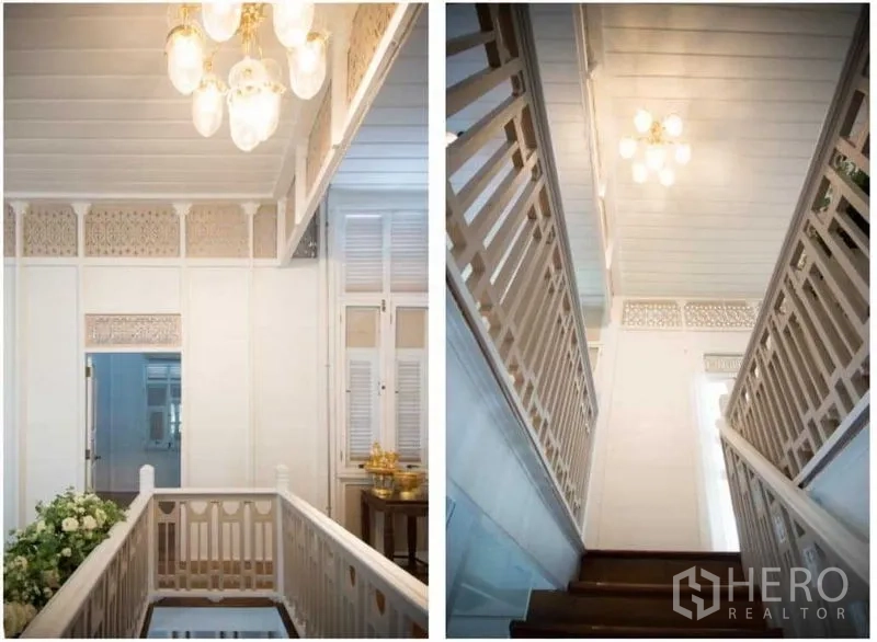 Detached House for rent in Bang Rak, Bangkok - Stairwell with carved railings and pendant chandeliers in a bright hallway.