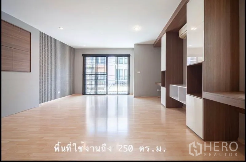 ทาวน์เฮาส์ ขายในKhlong Toei, Bangkok - ห้องอเนกประสงค์กว้างพื้นไม้โทนอ่อน ตู้บิลท์อิน และประตูเปิดออกไประเบียง