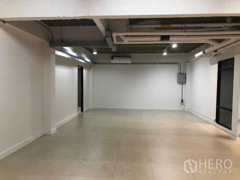 办公空间 出租在Phaya Thai, Bangkok - 65平米开放式办公室，外露管线天花、白色墙面与瓷砖地面。