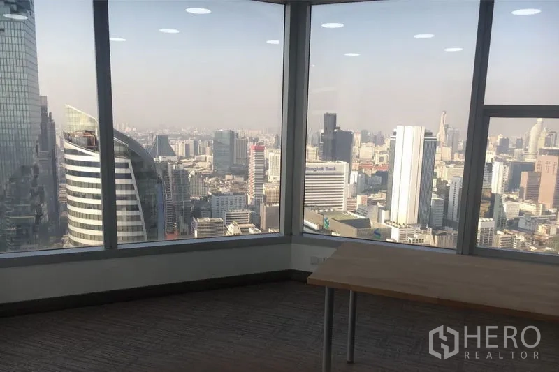 Office Space for rent in Sathon, Bangkok - Corner office with floor-to-ceiling windows offering a wide Bangkok CBD skyline view.