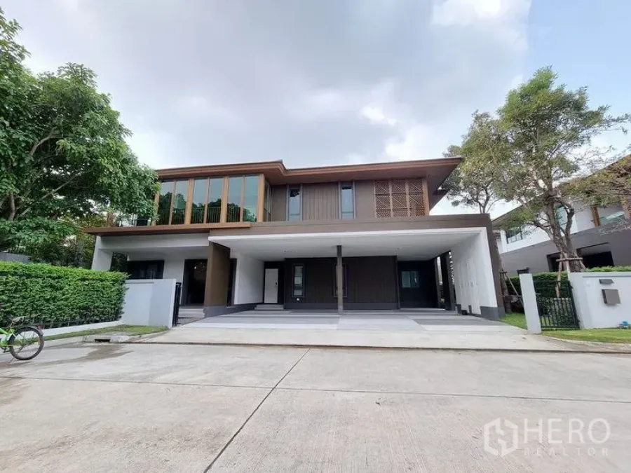 Detached House for rent in Prawet, Bangkok - Contemporary two‑storey facade with expansive covered driveway and parking.