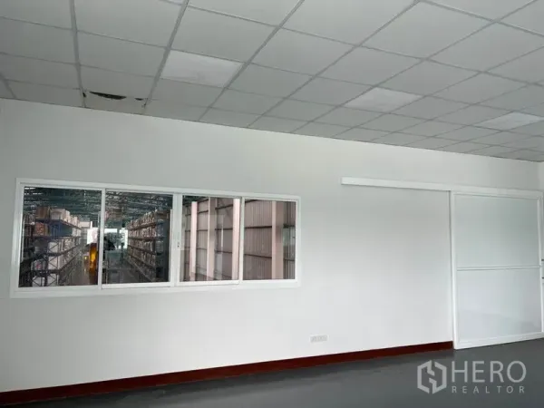 Warehouse for rent in Lat Krabang, Bangkok - Office viewing window looking out to racked storage aisles inside the warehouse