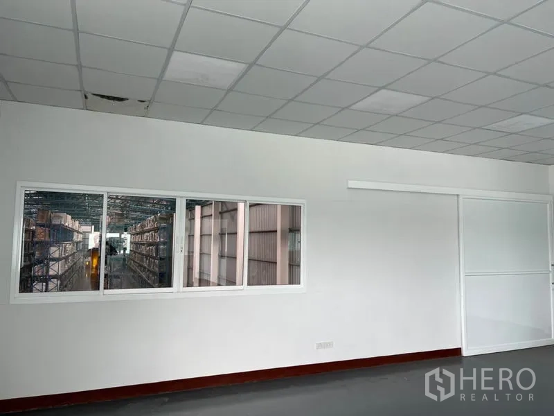 Warehouse for rent in Lat Krabang, Bangkok - Office viewing window looking out to racked storage aisles inside the warehouse